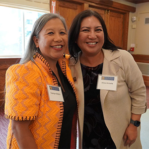 Carolyn Sideco poses and another woman pose together  