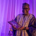 Vincent Matthews proudly holds his plaque  at the alumni Hall of Fame 